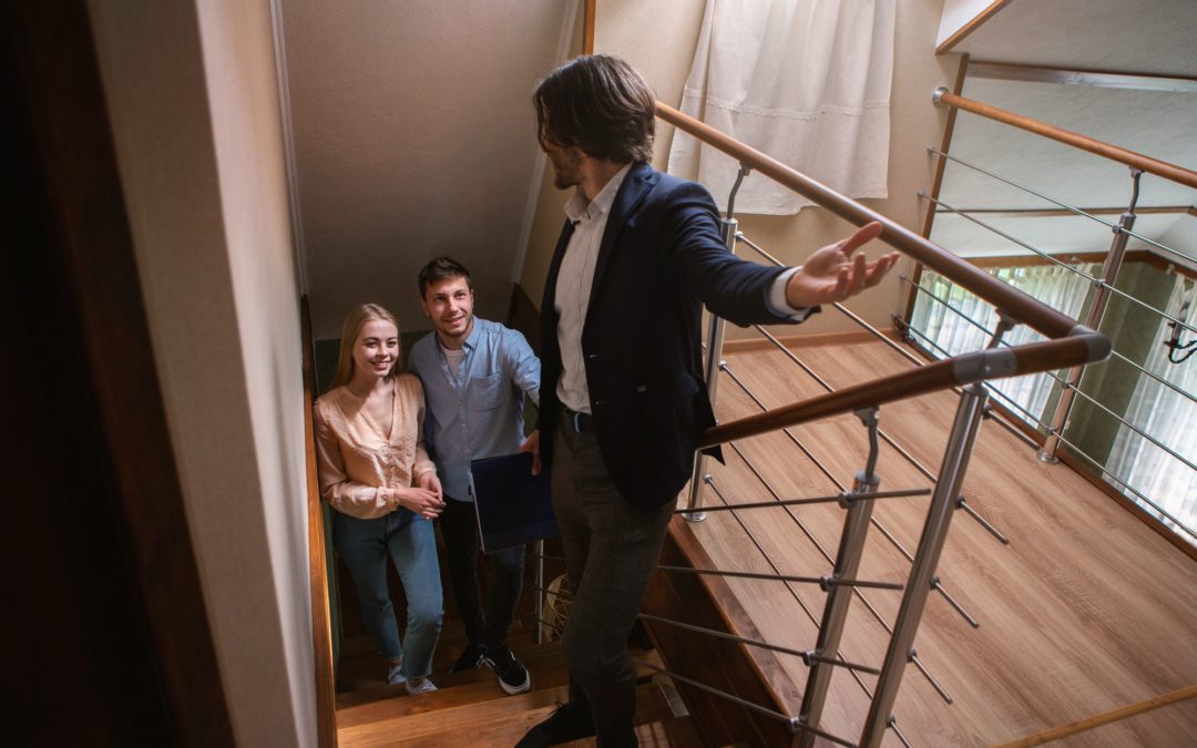 Real estate agent showing prospective buyers around property